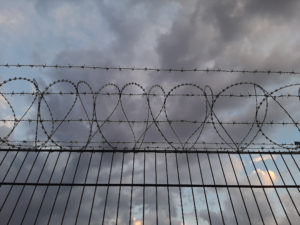 Low angle view of barbed wire against sky