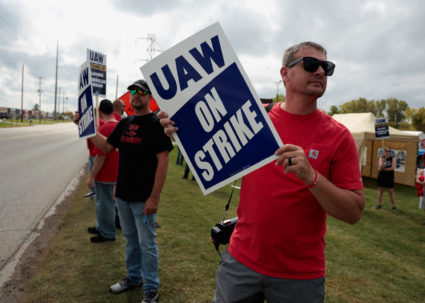 Striking United Auto Workers members, from the General Motors Lansing Delta Plant, picket on a street corner in Delta Town...