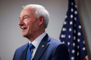 Former Arkansas Governor and Republican presidential candidate Asa Hutchinson greets people in Des Moines