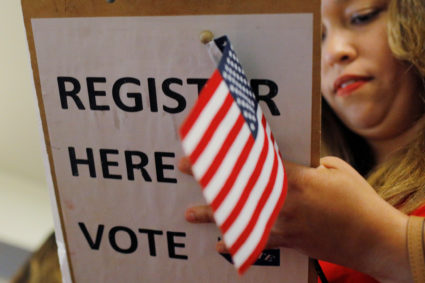 Pamela Marmolejos registers to vote after taking the oath to become a U.S. citizen in Boston
