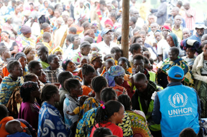 A UN worker monitors Congolese refugees who fled from the Democratic Republic of Congo by boat across Lake Albert, upon arrival at United Nations High Commission for Refugees (UNHCR) in settlement camp in Kyangwali, Uganda March 19, 2018. Photo by James Akena/REUTERS