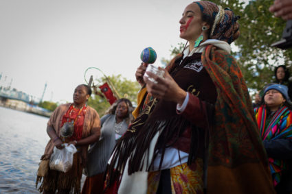 People gather on the shore of the East River during an indigenous sunrise water ceremony on Randall's Island as Indigenous Peoples' Day is observed in the U.S., in New York City, New York, U.S., October 9, 2023. Photo by Mike Segar/REUTERS