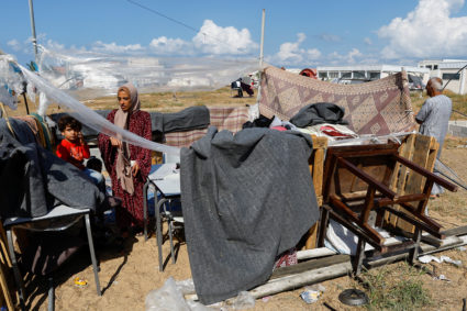 Palestinians, who fled their house amid Israeli strikes, shelter at a United Nations-run centre in Khan Younis
