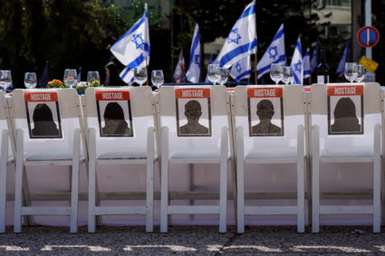A dinner table is set with empty chairs that symbolically represent hostages and missing people with families that are waiting for them to come home, following a deadly infiltration by Hamas gunmen from the Gaza Strip, in Tel Aviv, Israel October 20, 2023. Photo by Janis Laizans/REUTERS