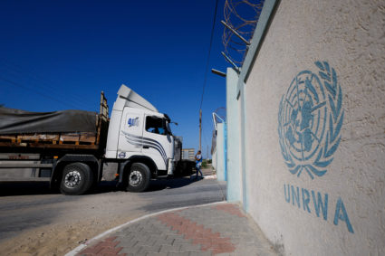 Aid trucks arrive at a UN storage facility in the central Gaza Strip