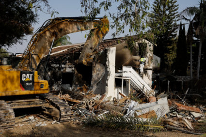 A forensic expert from a Zaka Rescue and Recovery team searches for dead bodies in a house, following a deadly infiltration by Hamas gunmen from the Gaza Strip, in Kibbutz Beeri in southern Israel October 22, 2023. Photo by Amir Cohen/REUTERS