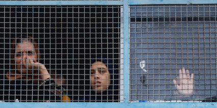 Palestinians, who have fled their homes due to Israeli strikes, watch a nearby Israeli strike as they take shelter in a UN-run school, in Khan Younis in the southern Gaza Strip, October 27, 2023. Photo by Mohammed Salem/REUTERS