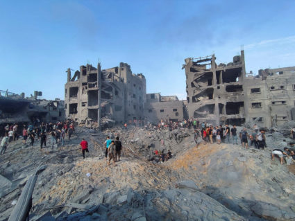 Palestinians search for casualties at the site of Israeli strikes on houses in Jabalia refugee camp