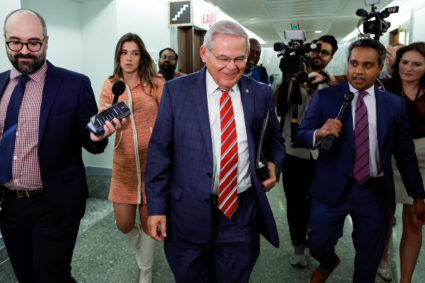 U.S. Senator Menendez is trailed by reporters on Capitol Hill in Washington