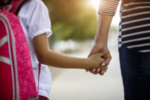 Mother and daughter holding hands