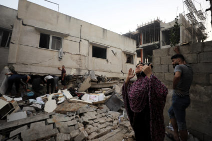 Palestinians work to rescue people at the site of an Israeli strike on a residential building in Gaza City