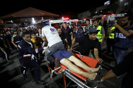 People are assisted at Shifa Hospital after an Israeli air strike hit the nearby Al-Ahli Hospital