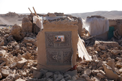 A family picture can be seen on the wall of a damaged house after the recent earthquake in Chahak village