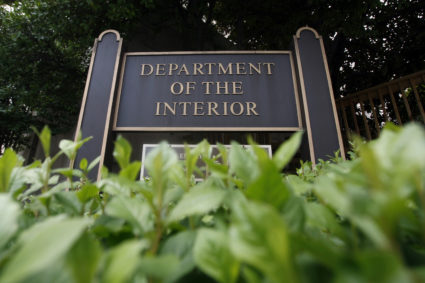 FILE PHOTO: A sign in front of the U.S. Interior Department is shown in Washington, September 10, 2008. The U.S. Interior Department employees who oversaw oil drilling on federal lands had sex and used illegal drugs with workers at the energy companies they regulated, an internal government report said on Wednesday. Photo by Jason Reed/REUTERS