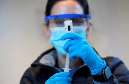 Nurse practitioner Sarah Gonzalez prepares to give a dose of the coronavirus disease (COVID-19) Moderna vaccine at a mass ...