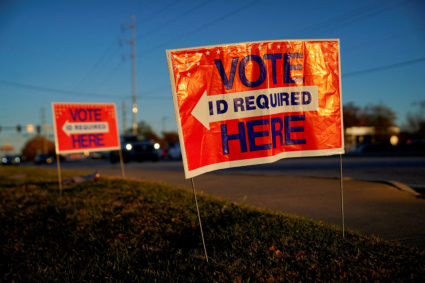 Signs direct voters to a polling location during early voting in the runoff U.S. Senate election between Democratic Senator Raphael Warnock and his Republican challenger Herschel Walker, in Columbus, Georgia, U.S. November 28, 2022. File photo by Cheney Orr/ Reuters