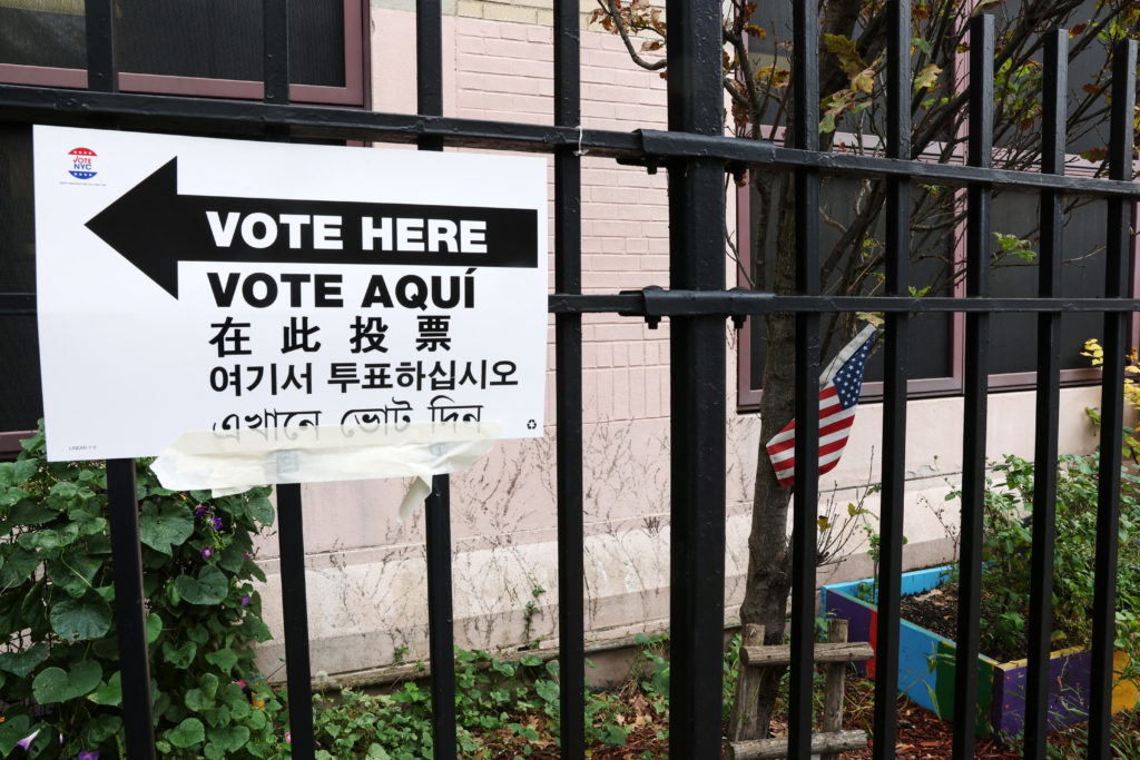A multi-lingual sign directs voters to the P.S. 166Q polling place in the Queens borough of New York City, U.S., November ...