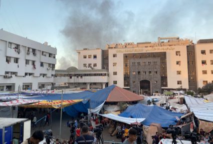 Smoke rises as displaced Palestinians take shelter at Al Shifa hospital, amid the ongoing conflict between Hamas and Israe...