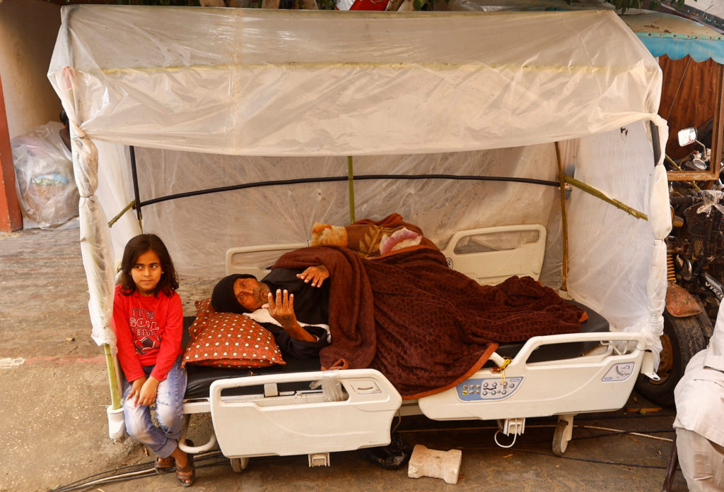 90-year-old Gazan patient shelters outdoors amid crowded hospital