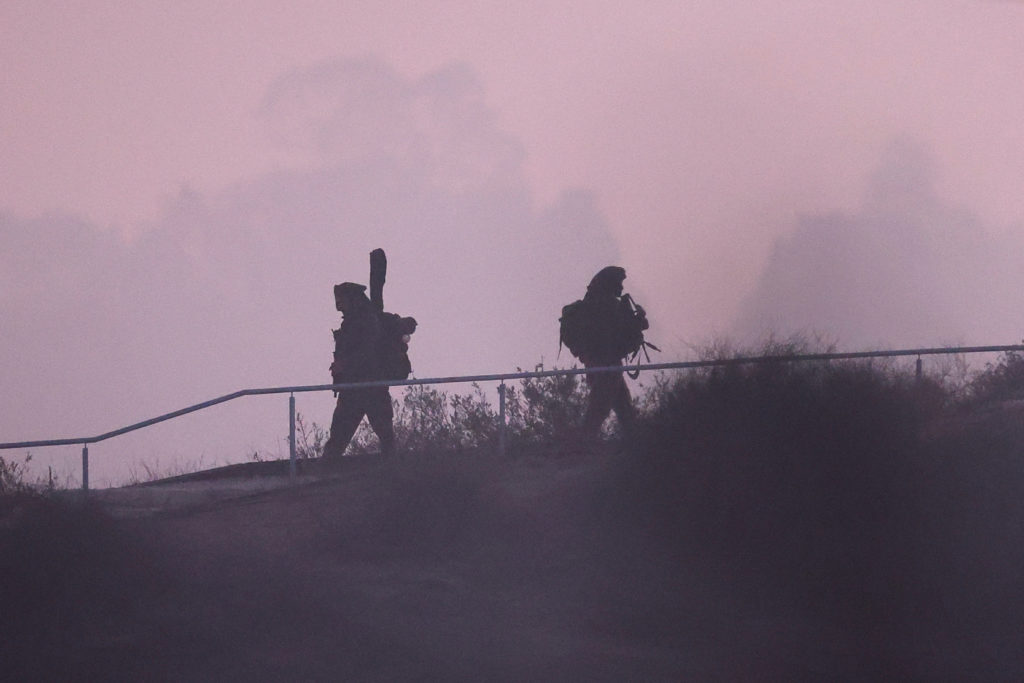 Soldiers of Israel's army move from the border with Gaza, as seen from Southern Israel