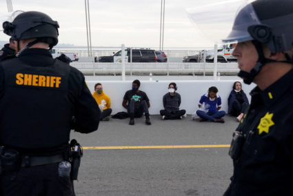 Security force members stand in front of detained people after demonstrators calling for a ceasefire in the ongoing conflict between Israel and the Palestinian Islamist group Hamas blocked the Bay Bridge, a key commuter route into the city which is hosting the Asia Pacific Economic Cooperation (APEC) CEO Summit in San Francisco, California, U.S. November 16, 2023. Photo by Loren Elliott/REUTERS