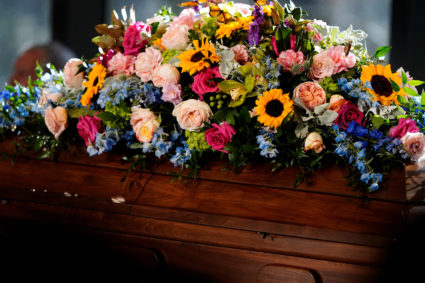 The casket of former U.S. first lady Rosalynn Carter is covered with a flower arrangement during a repose service at the Jimmy Carter Presidential Library and Museum in Atlanta, Georgia, U.S., Monday, Nov. 27, 2023. The former first lady died on Nov. 19. She was 96. Photo by Brynn Anderson/Pool via REUTERS