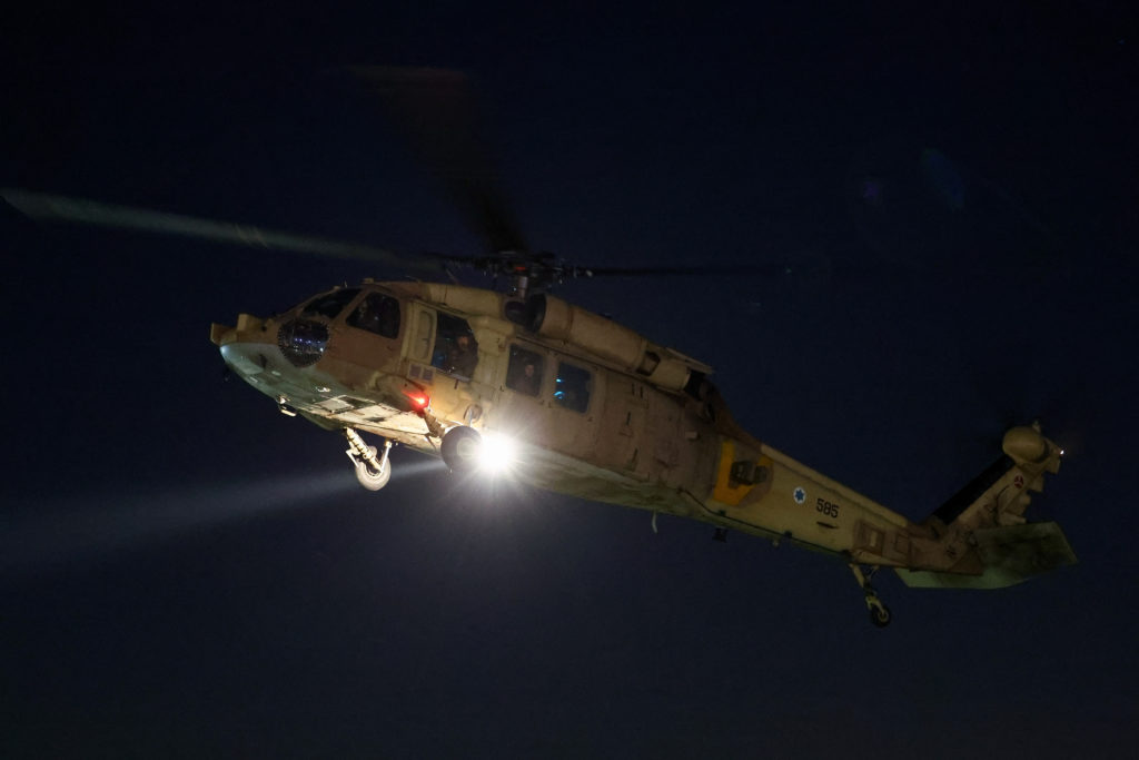 A helicopter carrying hostages released amid a hostages-prisoners swap deal between the Palestinian militant group Hamas a...