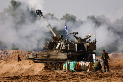 A mobile artillery unit fires on the Israeli side of the Israel-Gaza border
