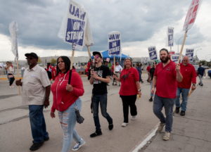 Striking United Auto Workers walk the picket line outside the Ford Michigan Assembly Plant in Wayne
