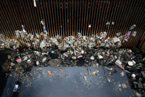 Garbage is seen in front of a floodgate at a canal in Bangkok