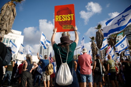 People take part in a demonstration against Israel's nationalist coalition government's judicial overhaul near the U.S. Co...