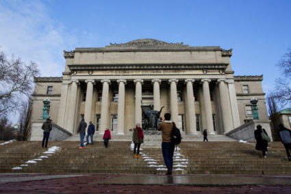 People walk outside the Library of Columbia University in New York