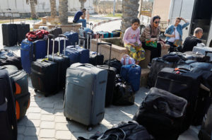 Palestinians holding foreign passports wait for permission to leave Gaza, at the Rafah border crossing with Egypt