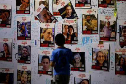 People gather as they await news of hostages expected to be released by Hamas, in Tel Aviv