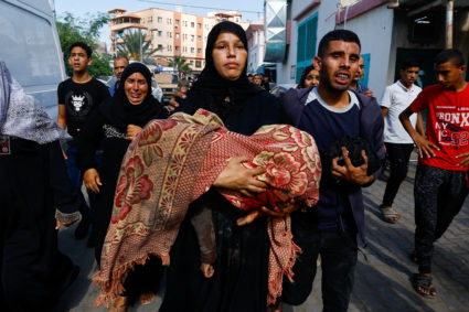 Mourners react next to bodies of Palestinians killed in Israeli strikes, in Khan Younis