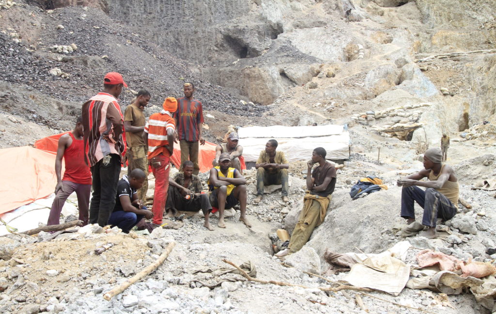 Artisanal miners sit outside a cobalt mine-pit in Tulwizembe, Katanga province, Democratic Republic of Congo