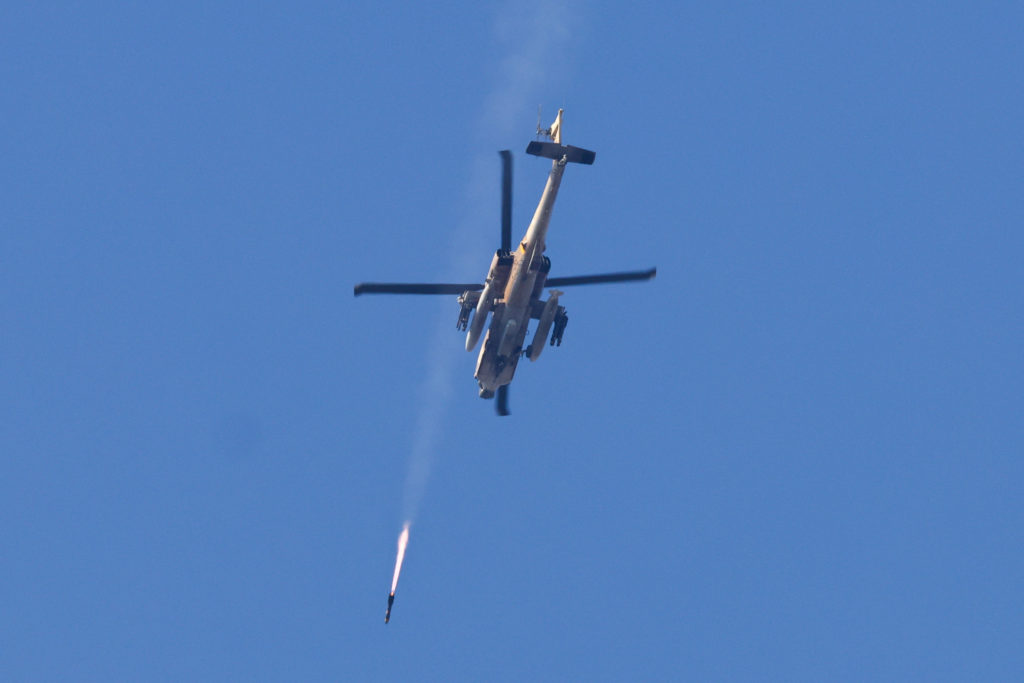 A helicopter fires a rocket as seen from southern Israel
