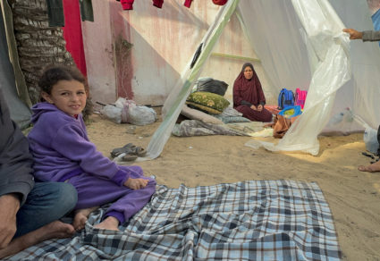 Displaced Palestinians, who fled their houses due to Israeli strikes, shelter in a tent camp, in Khan Younis