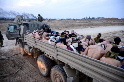 Israeli soldiers stand by a truck packed with shirtless Palestinian detainees, amid the ongoing conflict between Israel and the Palestinian Islamist group Hamas, in the Gaza Strip December 8, 2023. Photo by Yossi Zeliger/REUTERS
