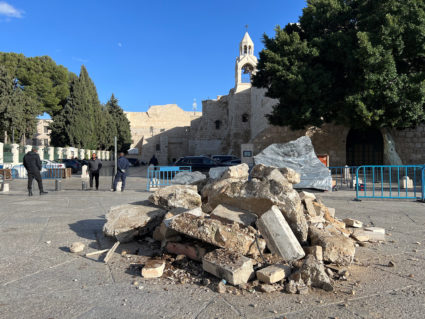 Workers prepare Christmas installation of grotto at manger square outside Church of Nativity in support with Gaza