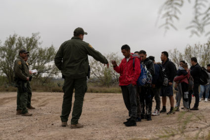 Migrants are apprehended by Border Patrol after wading across the Rio Grande River into Eagle Pass, Texas, U.S., December 22, 2023. Photo by Cheney Orr/REUTERS