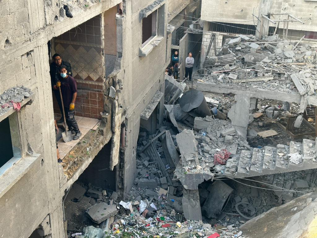 Palestinians inspect the site of an Israeli strike on a house in Rafah in the southern Gaza Strip