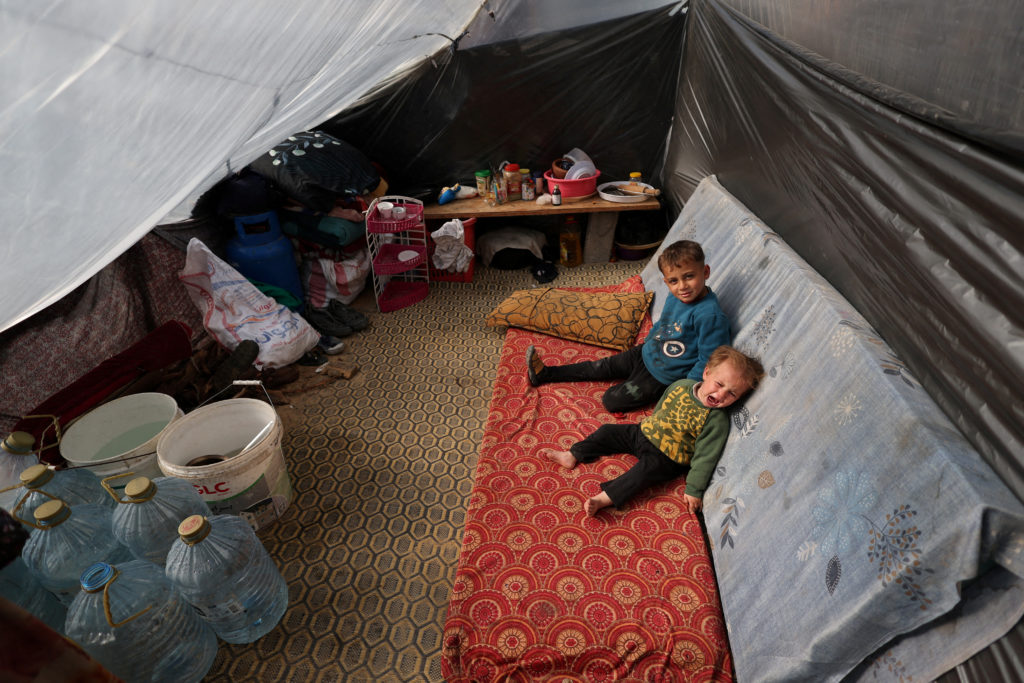 Displaced Palestinian children, who fled their homes due to Israeli strikes, shelter in a tent camp, amid the ongoing conflict between Israel and the Palestinian Islamist group Hamas, in Rafah, southern Gaza Strip, December 29, 2023. Photo by Ibraheem Abu Mustafa/REUTERS