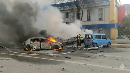 Firefighters extinguish a burning car following shelling in Belgorod