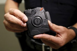 LAPD officer Stover demonstrates use of the body camera during a media event displaying the new body cameras to be used by...