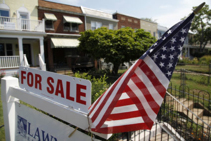 FILE PHOTO: A U.S. flag decorates a for-sale sign at a home in the Capitol Hill neighborhood of Washington, August 21, 2012. President Barack Obama said on Monday the U.S. housing market was "beginning to tick up" but was still not where it needs to be. Photo by Jonathan Ernst/Reuters