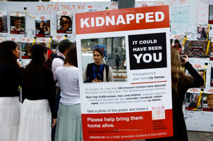 People put up posters depicting hostages who are being held in the Gaza Strip, in Tel Aviv