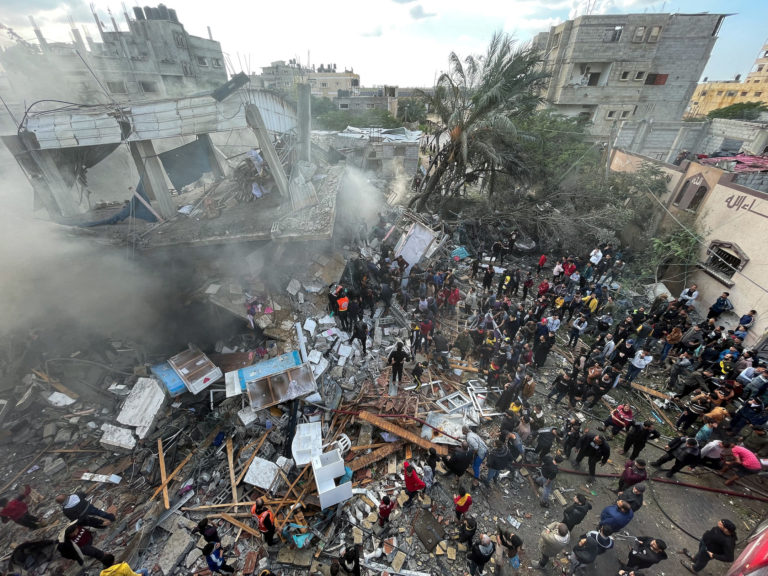 Palestinians inspect the site of an Israeli strike on a house in Rafah