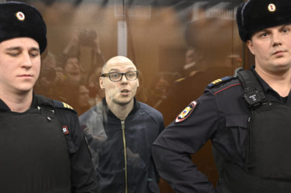 Russian poet Artyom Kamardin stands inside the defendants' glass cage during their verdict announcement at a court in Moscow on December 28, 2023. Russian poets Artyom Kamardin and Yegor Shtovba maintained their innocence but were sentenced to prison terms by Russian authorities, who have cracked down on any criticism of the military operation in Ukraine. Photo by Alexander NEMENOV / AFP via Getty Images