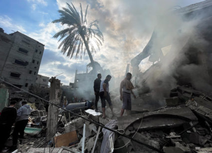 Palestinians inspect the site of an Israeli strike on a house in Rafah